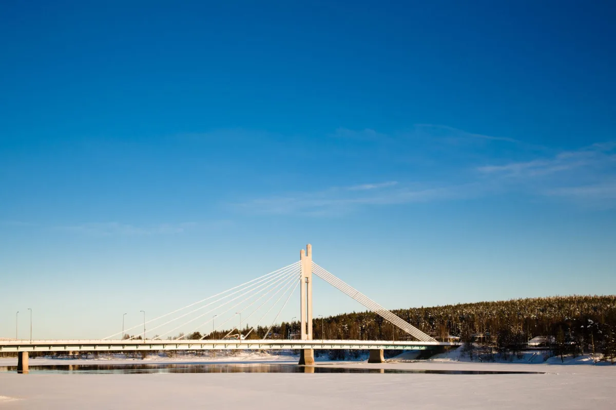 The Jätkänkynttilä bridge over the frozen Kemijoki in Rovaniemi on a clear winter day